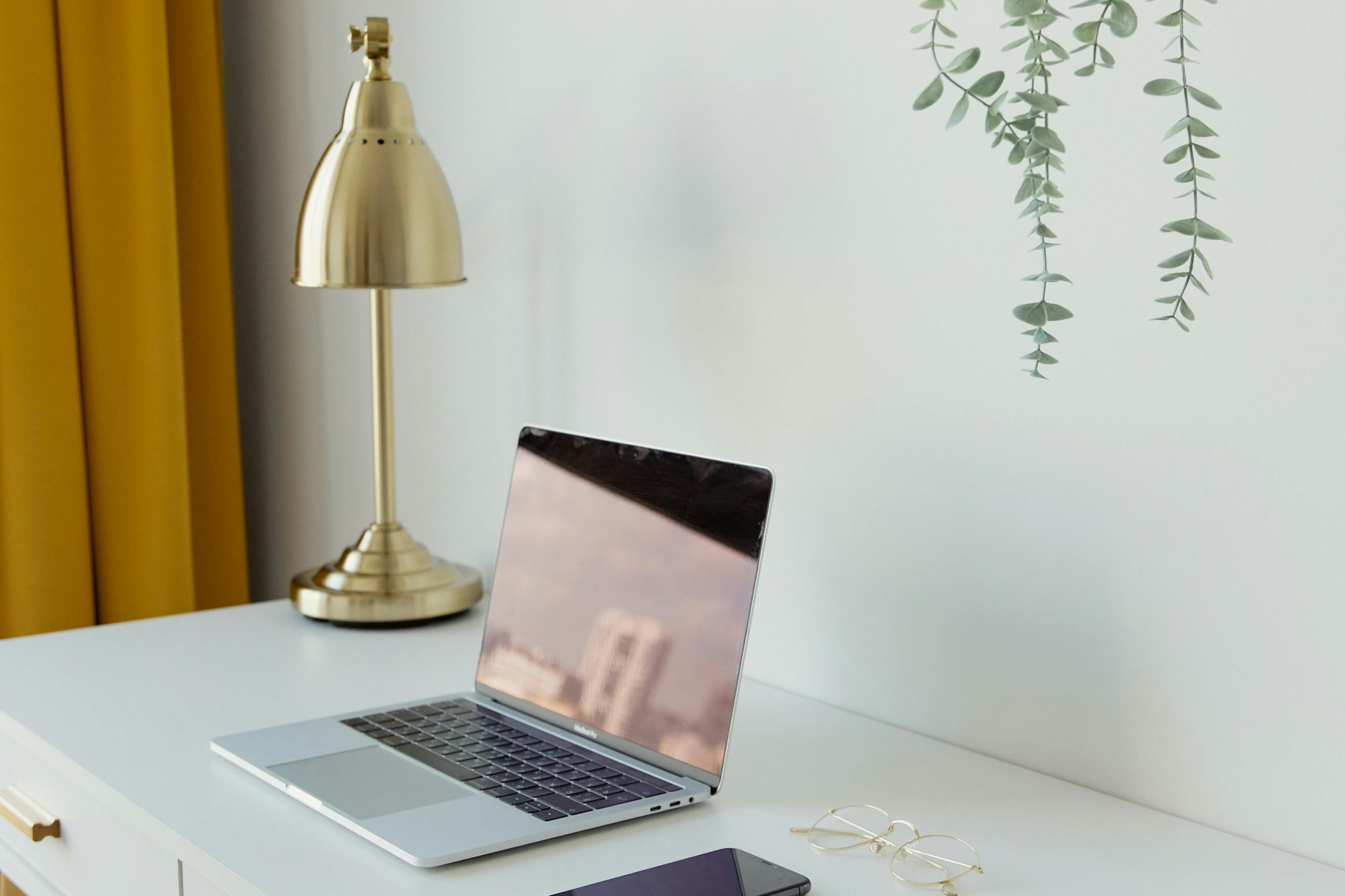 Organised desk with notebook, pen and accessories